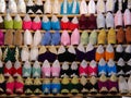 Rows of colourful, handmade babouche slippers on sale in souk, Morocco