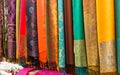 Rows of colourful silk scarfs hanging at a market stall Royalty Free Stock Photo