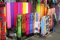 Rows of colourful silk scarfs hanging at a market stall in Indonesia