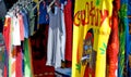 Rows of colourful tee shirts for sale at a Sunday market in Spain