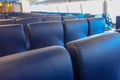 Rows of blue seats, elegant lounge inside a ferry. Comfortable chairs, windows in background Royalty Free Stock Photo