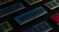 Rows of computer RAM (Random Access Memory) sticks are arranged on a dark Royalty Free Stock Photo