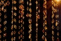 Crystal Beads Dangling with Golden Light Reflections Royalty Free Stock Photo