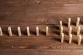 Rows of dominoes standing on wooden table