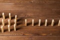 Rows of dominoes standing on wooden table