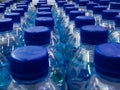 rows of drinking water bottles neatly arranged on minimarket shelves