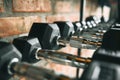 Rows of dumbbells. Close up of many black metal dumbbells on rack at gym Royalty Free Stock Photo