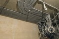 Rows of electrical cables laid in the corrugates on the ceiling