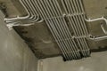 Rows of electrical cables laid in the corrugates on the ceiling Royalty Free Stock Photo