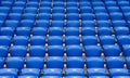 Rows of blue plastic armchairs on a tribune of stadium.