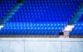 Rows of empty blue seats in a sports stadium. Royalty Free Stock Photo