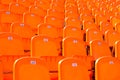 Rows empty bright oranje plastic seats in a stadium Royalty Free Stock Photo