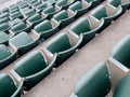 Rows of empty green stadium seats looking downwards