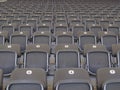 Rows of empty grey seats in an arena or stadium