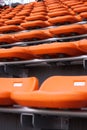 Rows of empty orange seats in a stadium Royalty Free Stock Photo