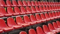 Rows of empty red outdoor stadium seats in perspective Royalty Free Stock Photo