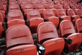 Rows of empty red stadium seats going upward Royalty Free Stock Photo