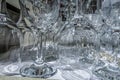 Rows of empty wine glasses close up. Glass goblets on the white table. Royalty Free Stock Photo