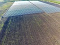 Rows of filmy greenhouses in the . Growing vegetables in a closed ground. Greenhouses in the field Royalty Free Stock Photo