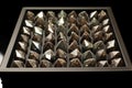 rows of finished diamonds in a storage tray