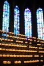 Rows of firing candles in catholic church. Royalty Free Stock Photo