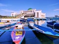 Rows of fishing boats, with the background of the Islamic center mosque in the city of Baubau.