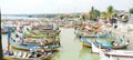 Rows of fishing boats parked on the beach during the day