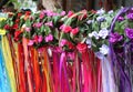 Rows of flower-covered girls headbands with colorful flowing ribbon streamers.