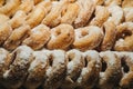 Rows of fresh donuts covered in white sugar