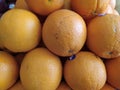 The rows of fresh oranges in the supermarket