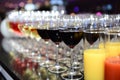 Rows of full champagne, sparkling wine and red wine glasses. Dining, drink. Royalty Free Stock Photo