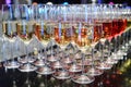 Rows of full champagne, sparkling wine and red wine glasses. Dining, drink. Royalty Free Stock Photo