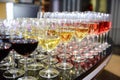 Rows of full champagne, sparkling wine and red wine glasses. Dining, drink. Royalty Free Stock Photo