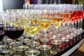 Rows of full champagne, sparkling wine and red wine glasses. Dining, drink. Royalty Free Stock Photo