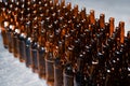 Rows of glass beer bottles brown color close up. Rows of glass beer bottles.