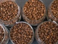Rows of glass jars with coffee beans of different varieties top view Royalty Free Stock Photo