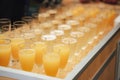 Rows of glasses with various colorful drinks standing on buffet table. Celebration, birthday, party, wedding concept.