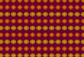 Rows of glowing yellow and orange circles form a seamless repeating pattern on a purple background creating a vibrant abstract Royalty Free Stock Photo