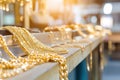 Rows of gold chains glittering on display in jewelry workshop Royalty Free Stock Photo