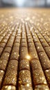 Rows of gold-colored cylinders, covered in glitter, create a shimmering, reflective Royalty Free Stock Photo