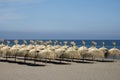 Rows of grass umbrellas waiting for tourits.