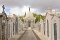 Rows of graves and chapel with bronze statue of mourning woman on top