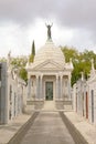 Rows of graves and chapel with bronze statue of mourning woman on top