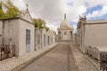 Rows of graves and chapel with bronze statue of mourning woman on top