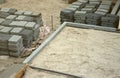 Rows of gray and dark grey walkway slab lying outdoors. Material for Paving Slabs by mosaic in progress. Cobblestone Royalty Free Stock Photo