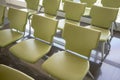 Rows of green chairs on dark granite tile floor Royalty Free Stock Photo