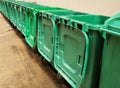 Rows of green plastic recycling bin. Royalty Free Stock Photo