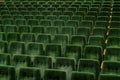 Rows of green seats in empty assembly hall for performance