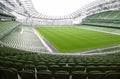 Rows of green seats in an empty stadium