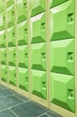 Rows of green student lockers in hall of school